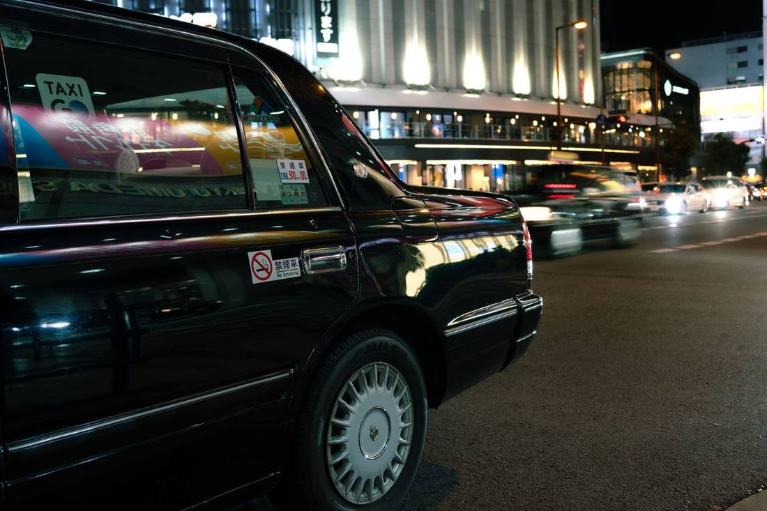 A black limousine on a city street after dark