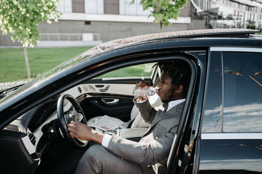The interior of a black SUV with bottled water