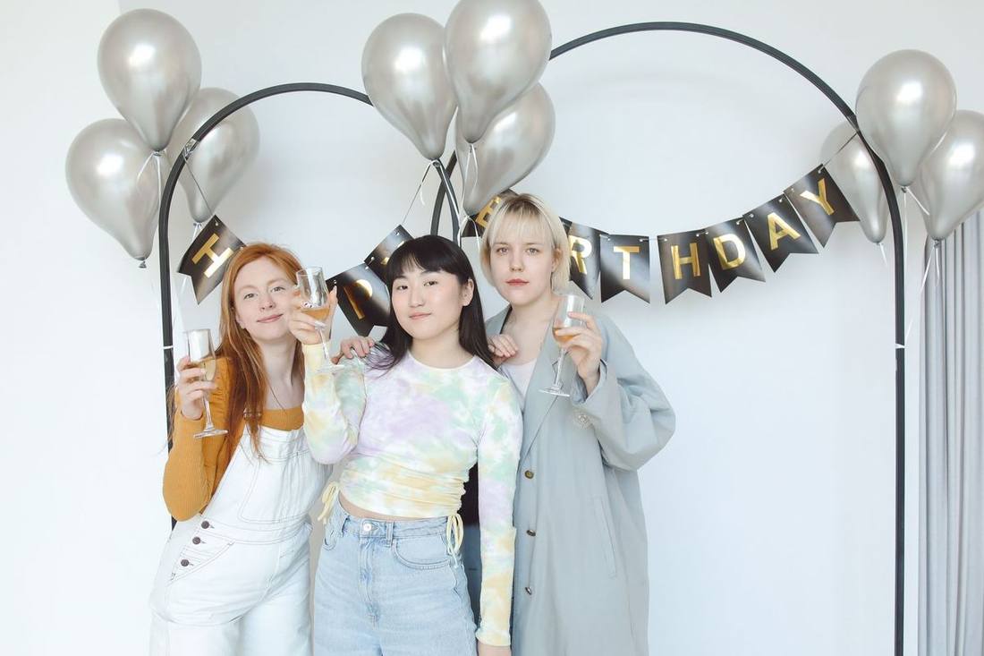 Friends toasting inside a stretch SUV on a birthday night out