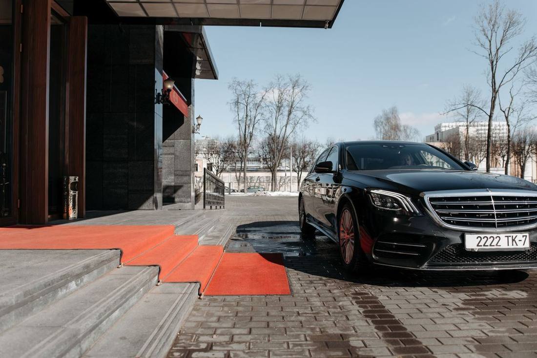 A black sedan at a hospital entrance loop