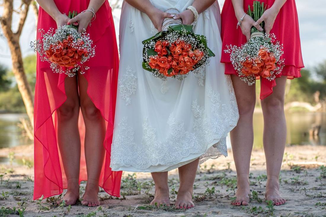 Bridesmaids in gowns boarding a Sprinter van through its sliding door
