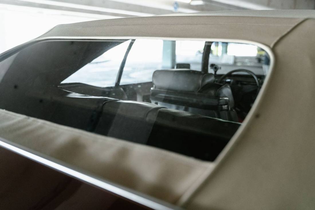 The second-row captain's chairs and rear screens inside a Cadillac Escalade