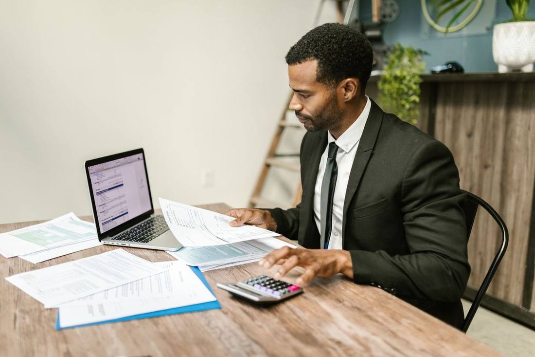 A travel manager reviewing account reports on a laptop