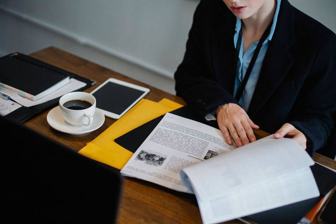 A travel manager reviewing supplier documents at a desk