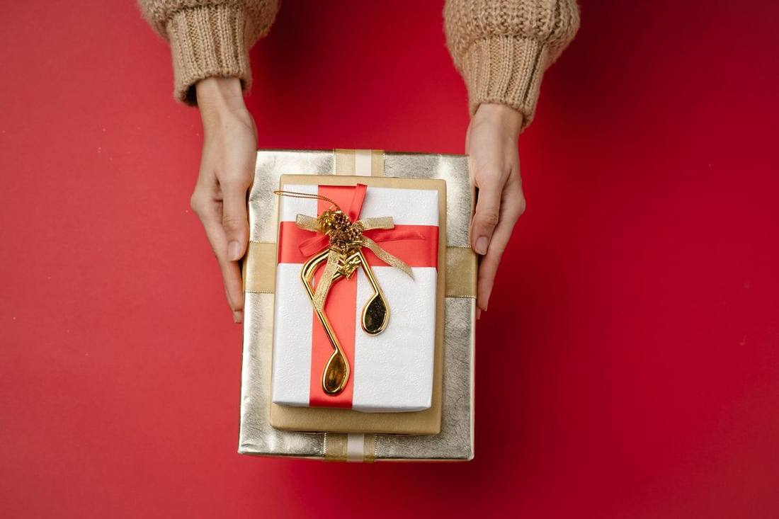 Guests with wrapped gifts stepping from a Sprinter van at a restaurant's door