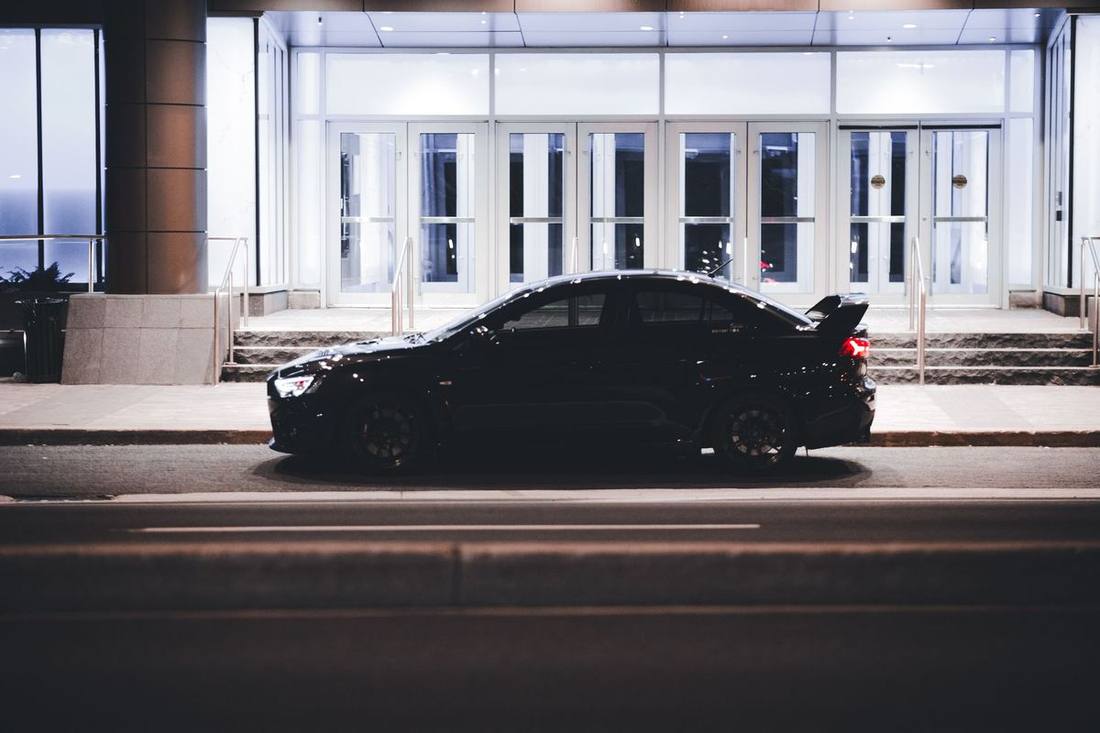A black sedan at a tower lay-by on Adelaide Street