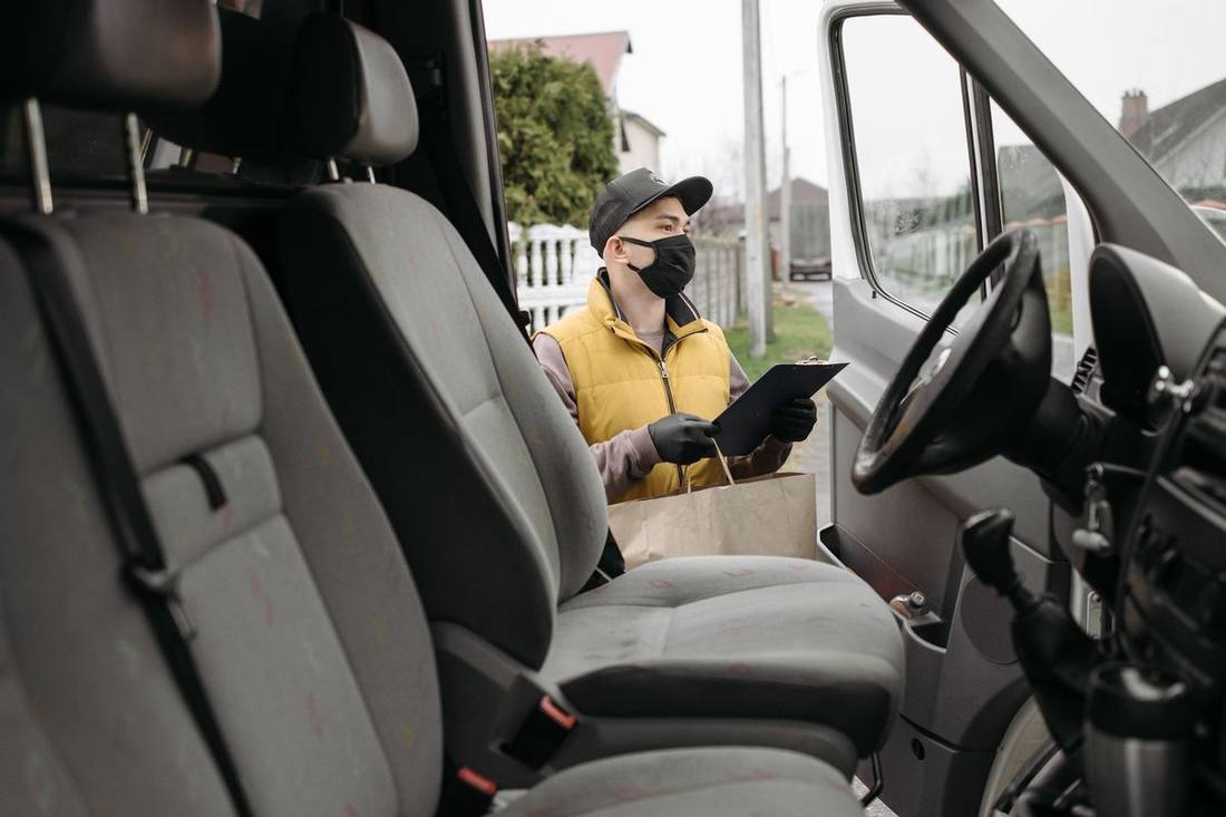 A maintenance log clipboard on a fleet vehicle's dashboard listing oil changes, brake inspections and tire depths