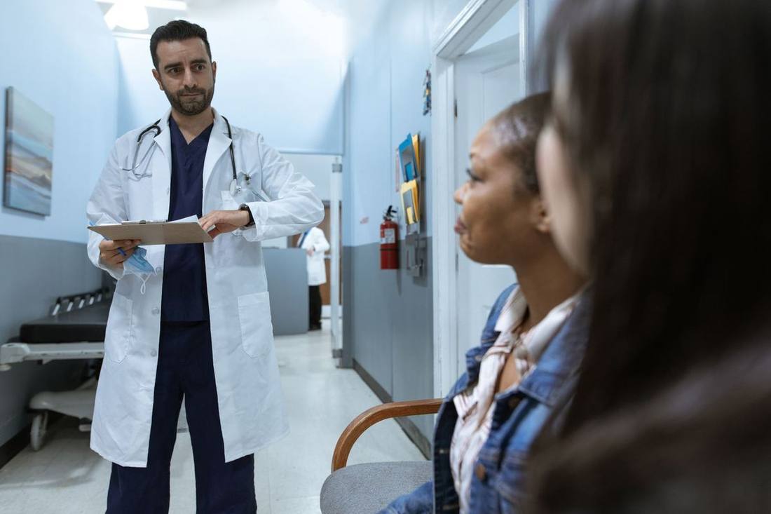 A visiting physician entering a black sedan at a hospital's physicians' entrance