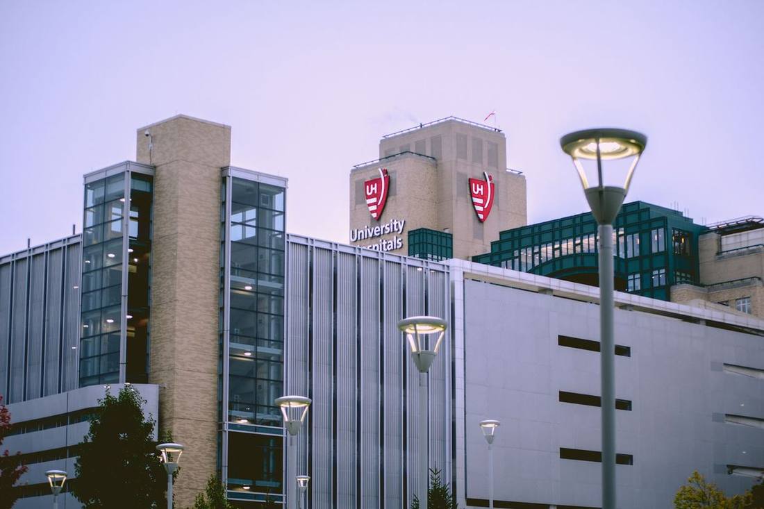 University Avenue's hospital row with a black sedan at a hospital entrance loop
