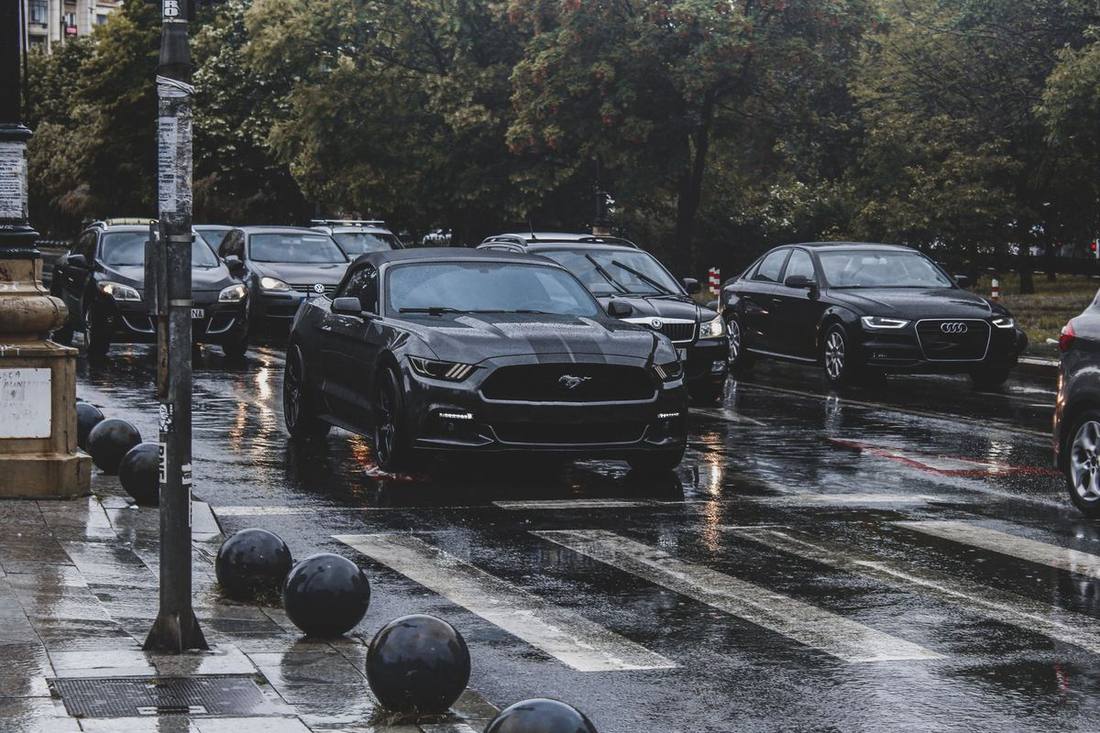 A black SUV and sedan in a Toronto laneway