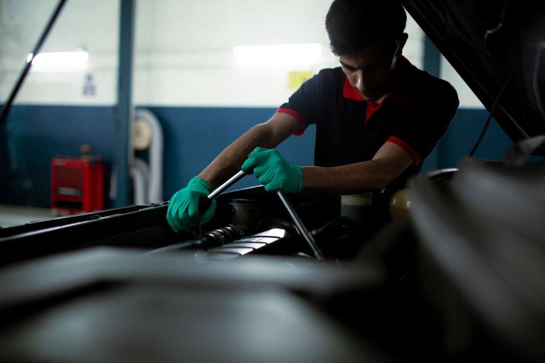 A chauffeur checking a vehicle before a shift