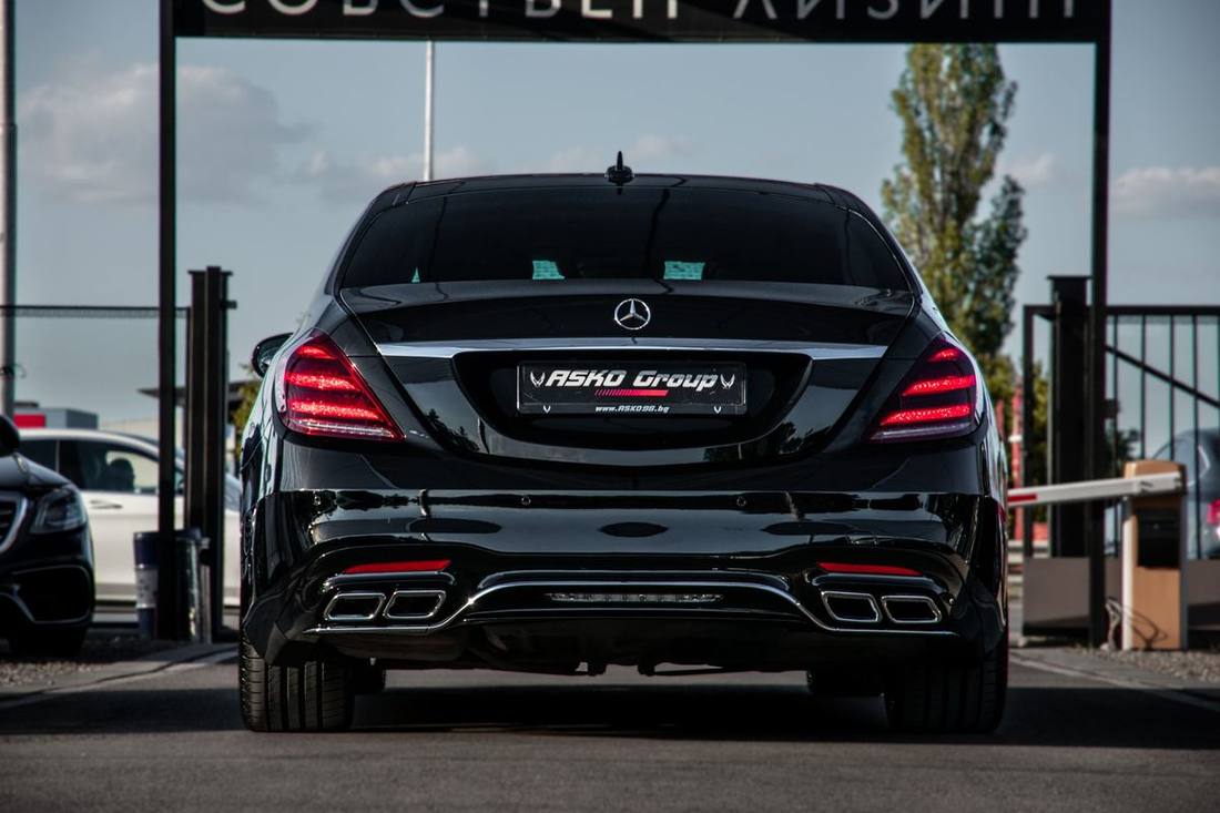 The reclined executive rear seat of a Mercedes S-Class with the leg rest raised and the tablet lit