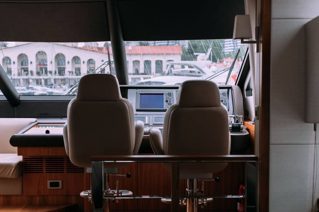 The interior of an executive Sprinter with leather captain's chairs, a centre aisle and a forward screen