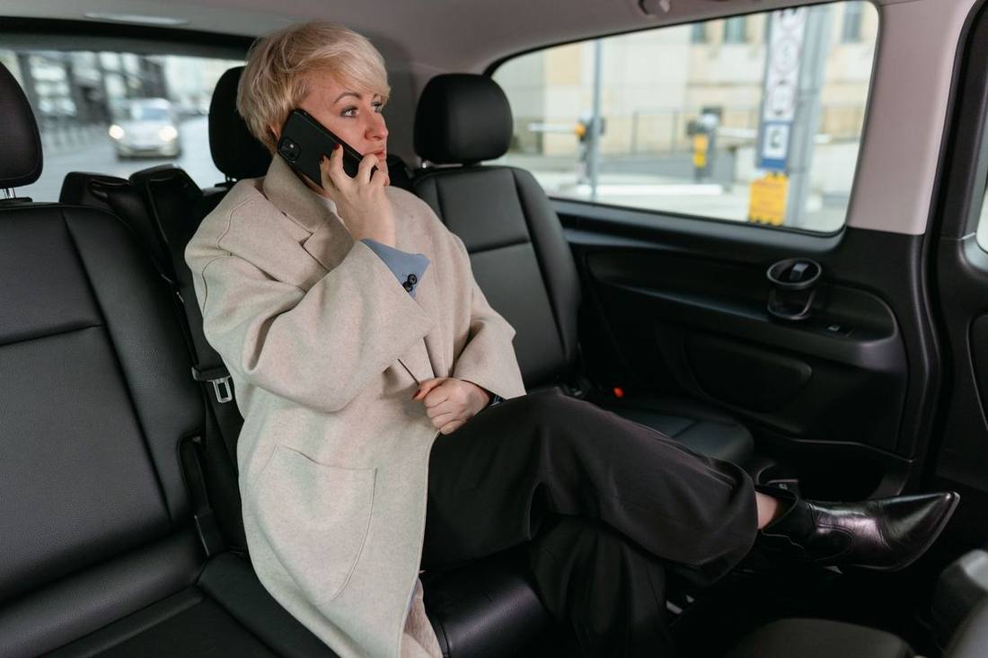 A chauffeur waiting at the pre-arranged pickup zone