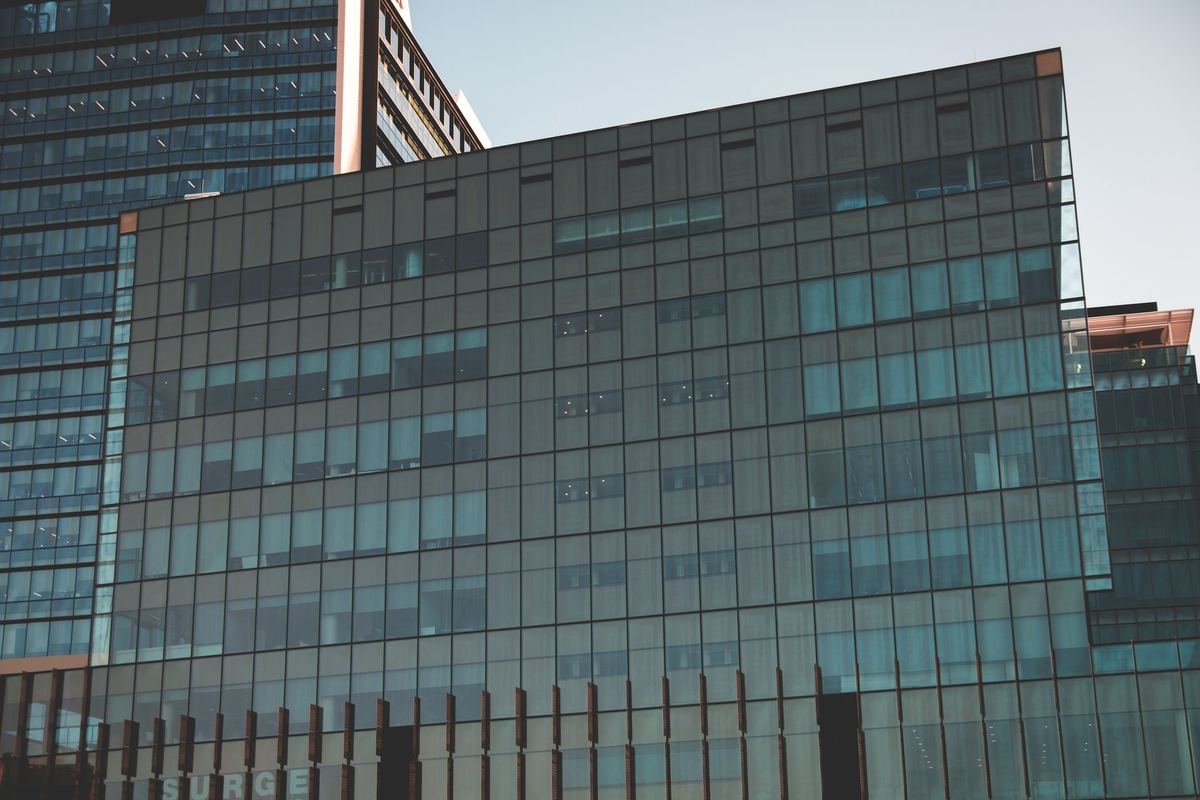 The Four Seasons Centre's glass facade on University Avenue with a black sedan in the lay-by