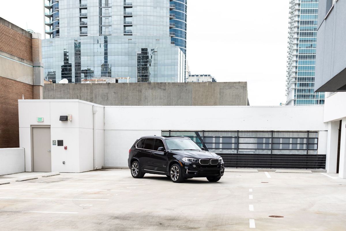 Black SUVs lined up on a Yorkville side street outside a festival talent hotel