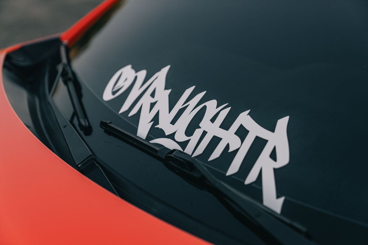 A City of Toronto limousine licence decal on the windshield of a black sedan