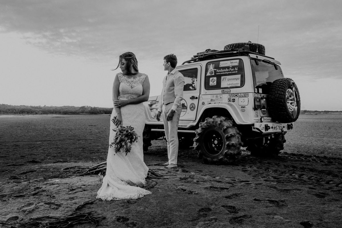 A bride and groom with a black stretch SUV at a Toronto waterfront photo location