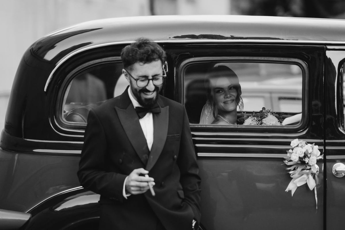 A bridal party in a black stretch SUV outside a Distillery District venue