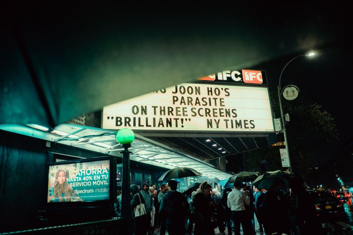 Festival crowds under a cinema marquee after a late screening