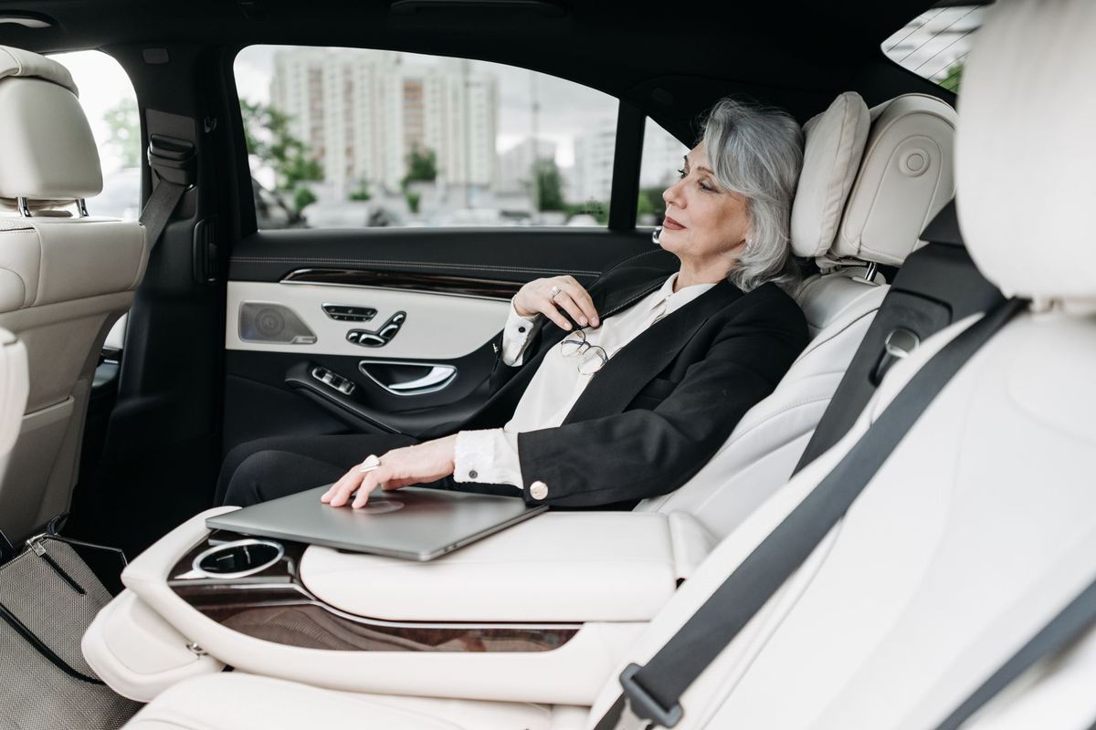 Working in the rear of a premium sedan between meetings