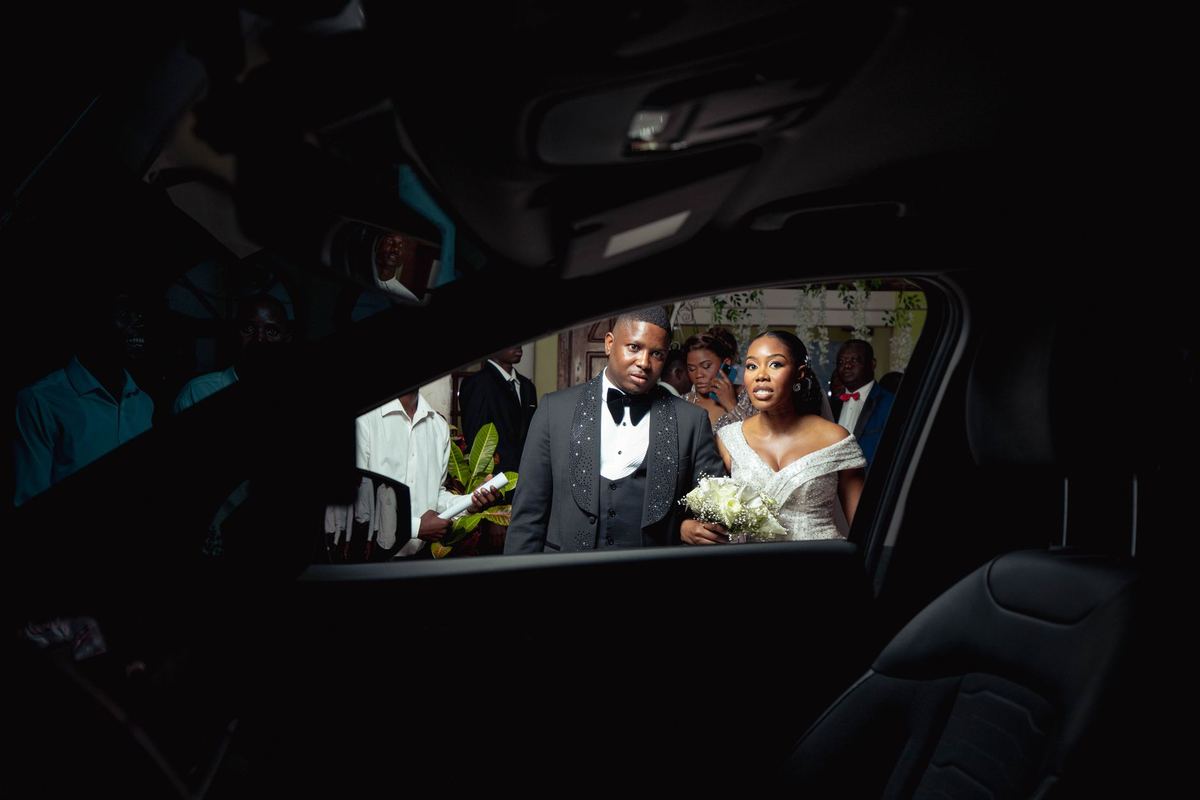 The couple in the back of the car after the ceremony